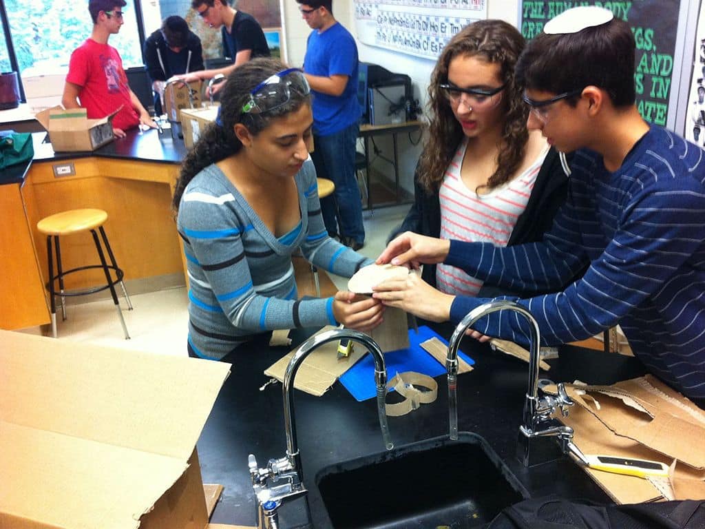 Three students working in a lab together
