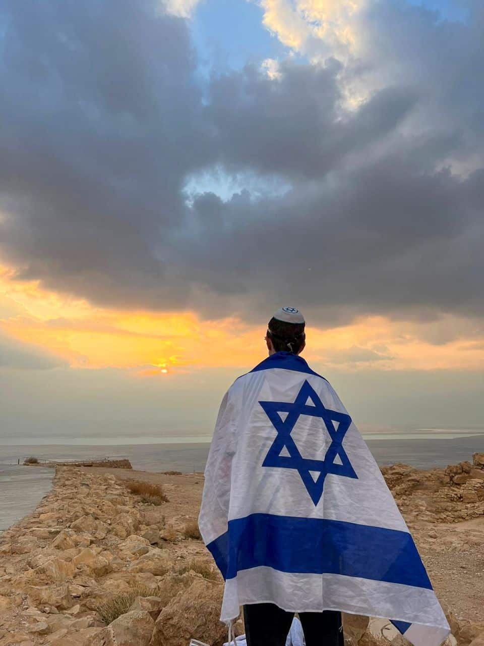 Jewish man draped in Israel flag
